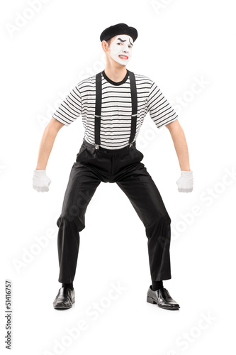 Full length portrait of a young mime artist lifting something im