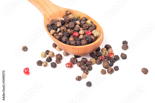 Pepper in a wooden spoon isolated on a white background