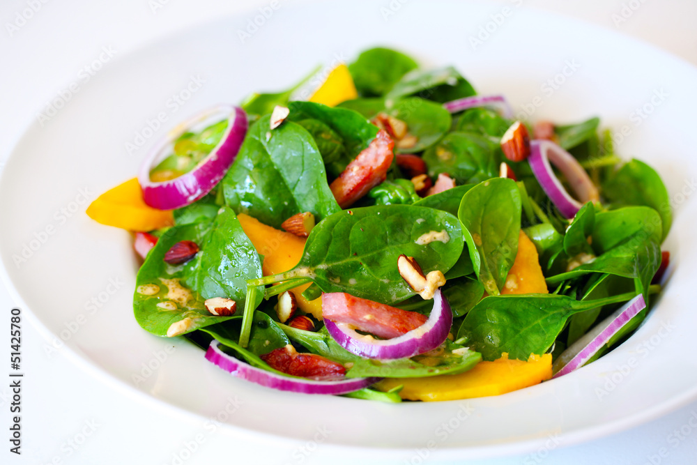 Spinach salad with mango, ham, onion and almonds