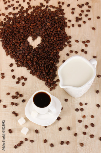 A cup of strong coffee and sweet cream on wooden table close-up © Africa Studio
