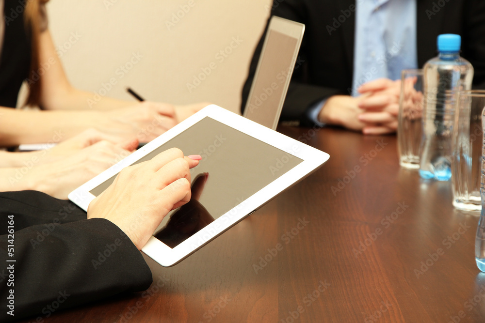 Female hands with digital tablet on office background. Female hands with digital tablet on office background.