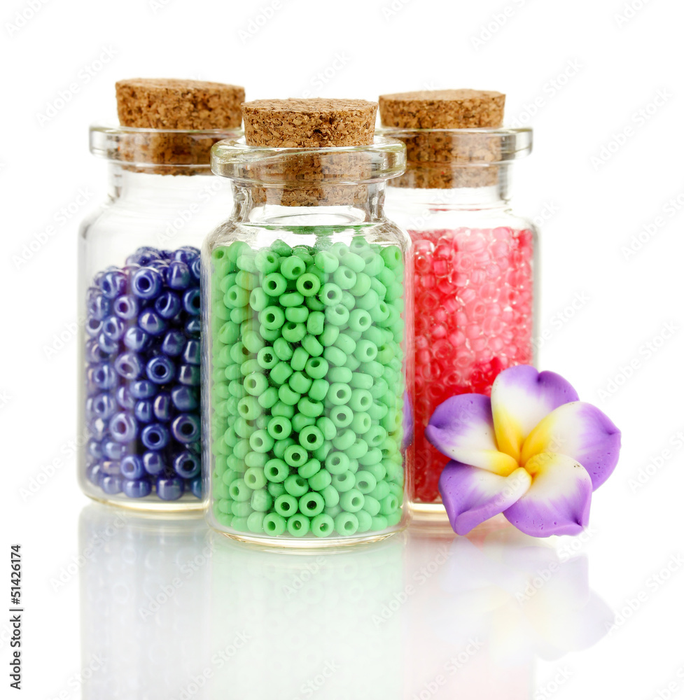 Little bottles full with colorful beads isolated on white Little bottles full with colorful beads isolated on white