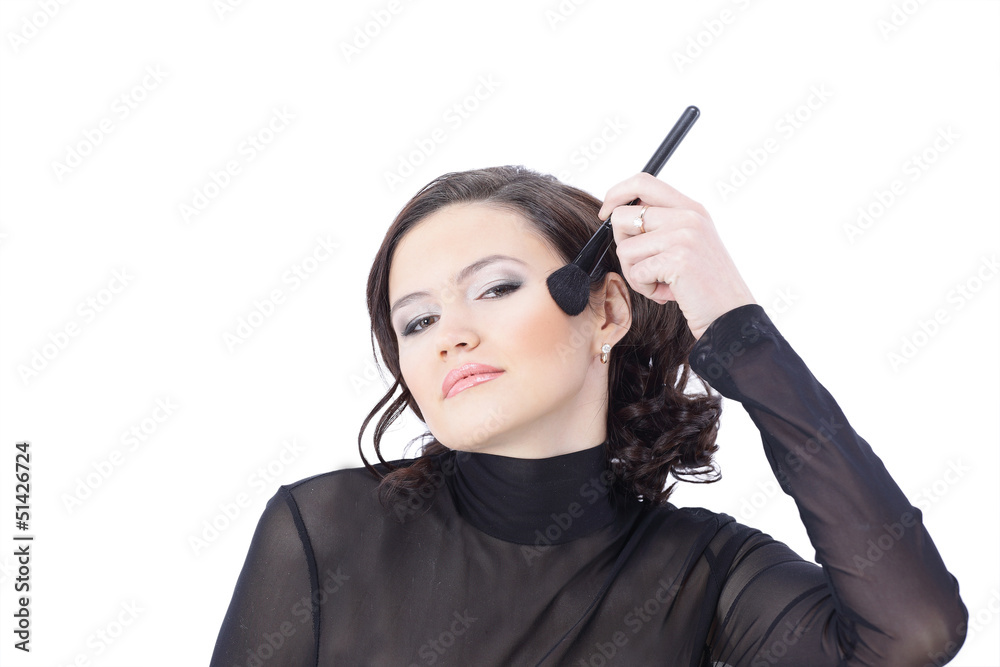 Obraz premium Beautiful woman with makeup brush near her face