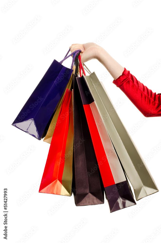 Hand of a woman holding many shopping bags.