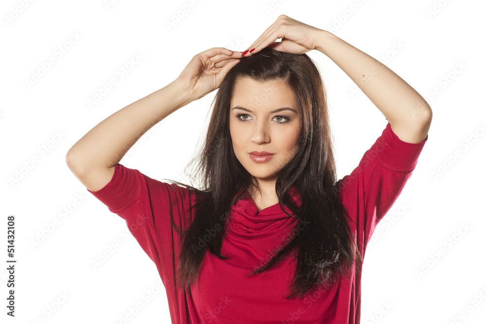 brunette with blue eyes adjusts hairpin in her hair brunette with blue eyes adjusts hairpin in her hair