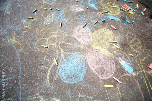 Chalk drawings, made by children on asphalt, and pieces of chalk
