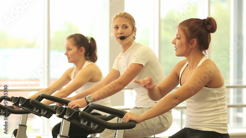 Group of women doing sport spinning in the gym