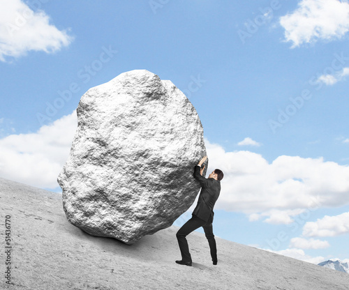 businessman pushing stone