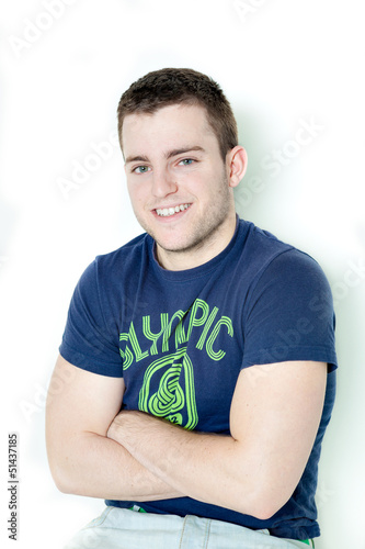 Handsome man smiling at camera with arms crossed