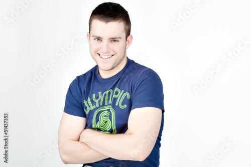 Handsome man smiling at camera with arms crossed