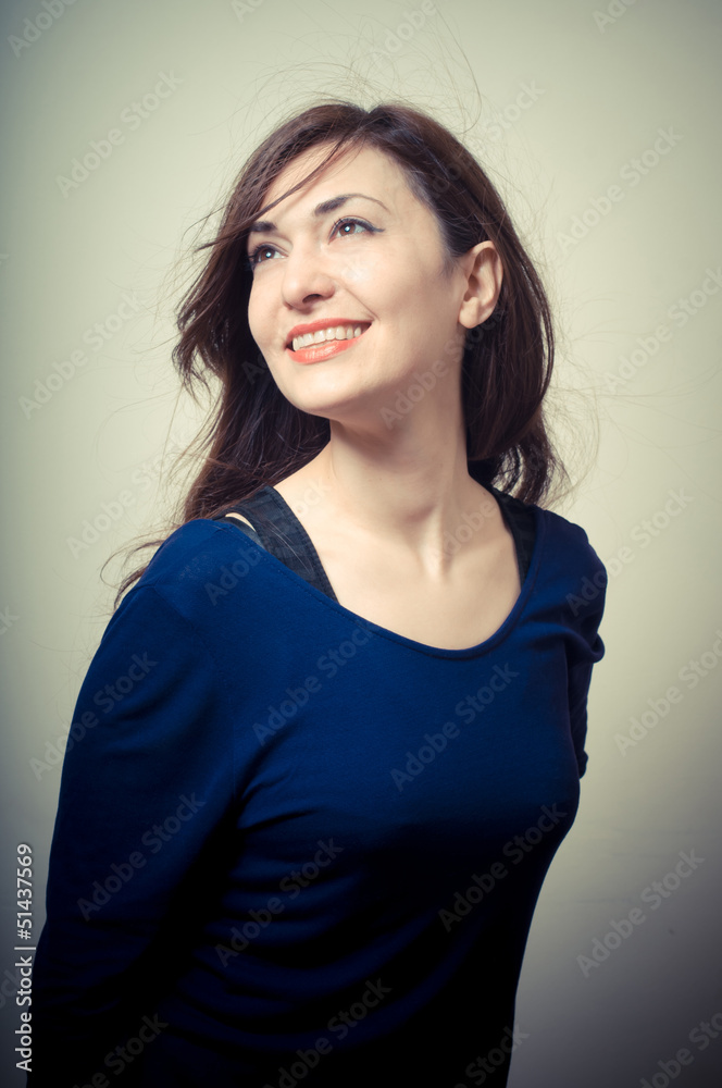 portrait of beautiful girl with long hair and blue sweater