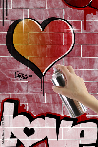 Heart graffiti on red brick wall
