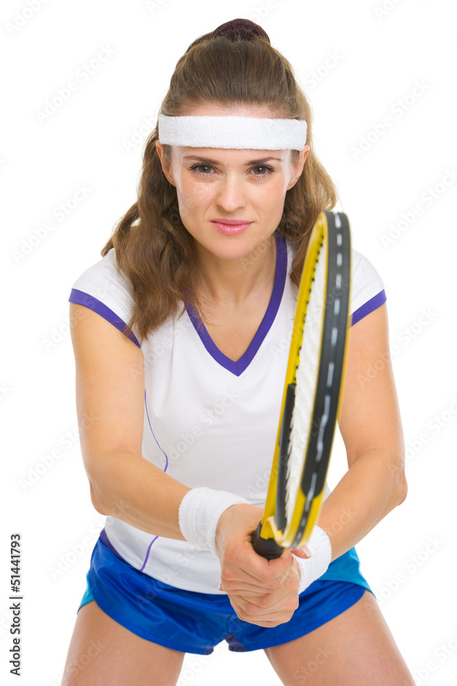 Smiling female tennis player ready to hit ball Smiling female tennis player ready to hit ball
