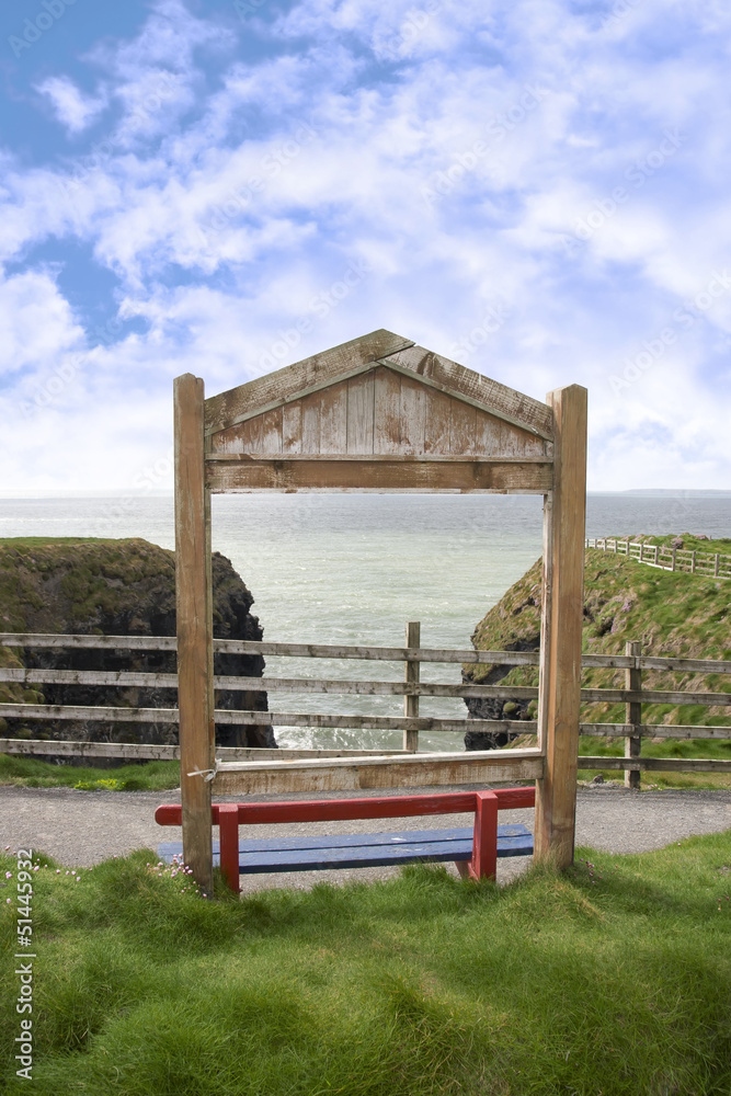 a wooden red bench framed with a sea view