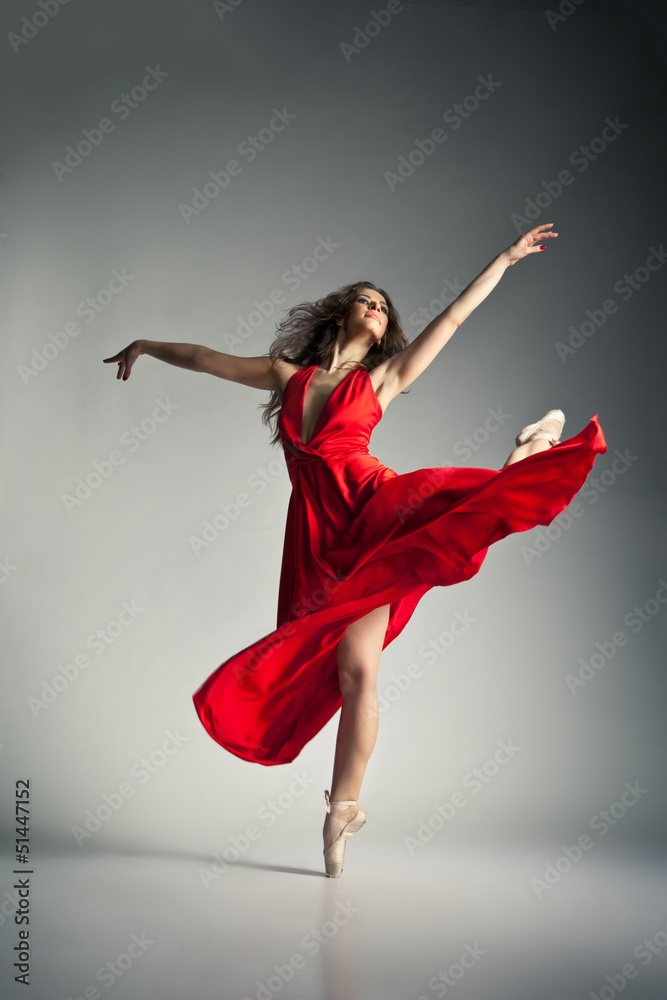 Ballet dancer wearing red dress over grey - obrazy, fototapety, plakaty 