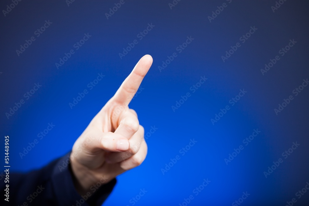 Woman's hand with finger, blue background
