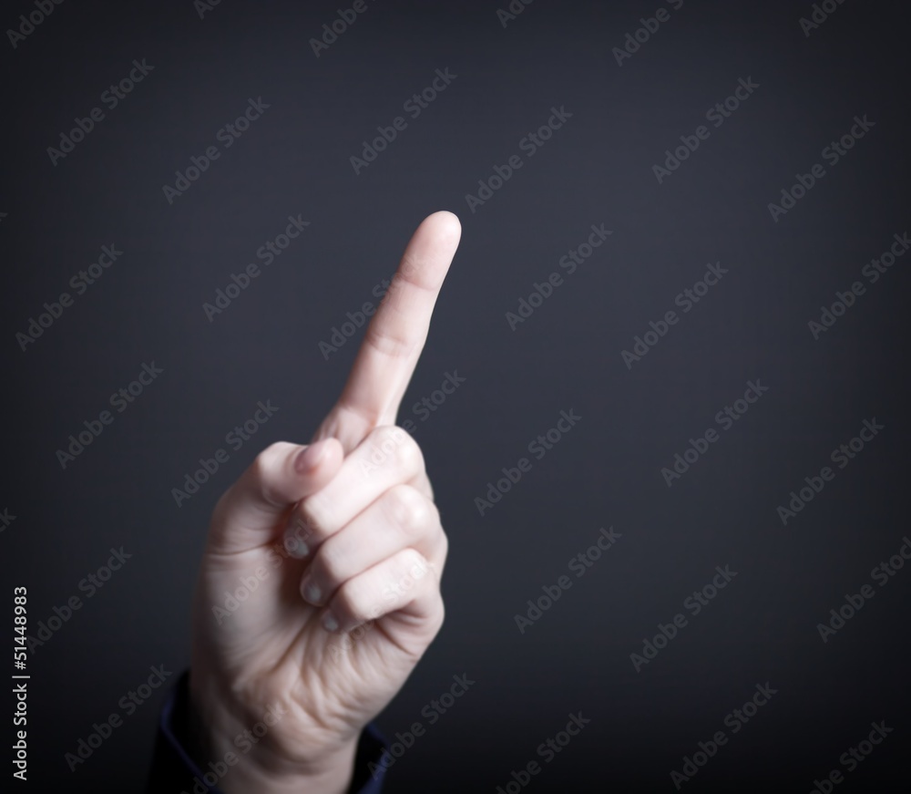 Woman's hand with finger, dark background Woman's hand with finger, dark background