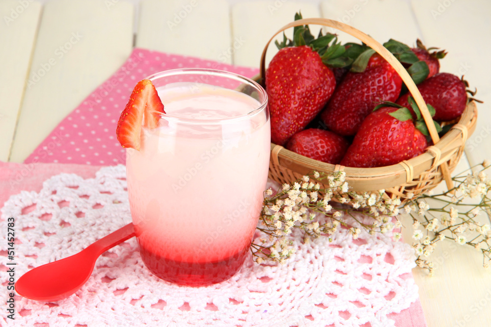 Delicious strawberry yogurt in glass on wooden table close-up Delicious strawberry yogurt in glass on wooden table close-up