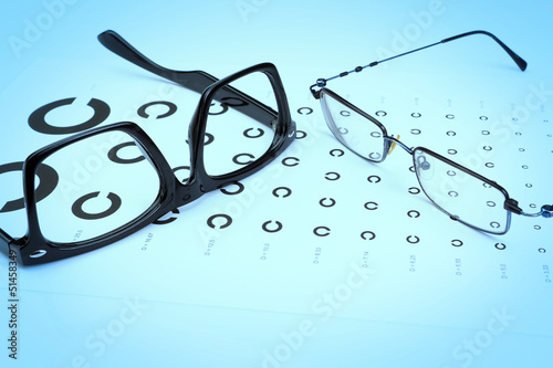 Table Golovin and glasses eye tests on a blue background.