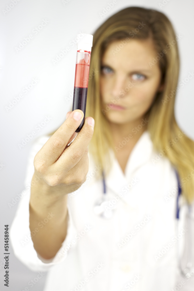 Strong serious doctor holding blood sample for research