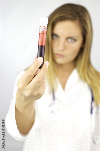 Strong serious doctor holding blood sample for research
