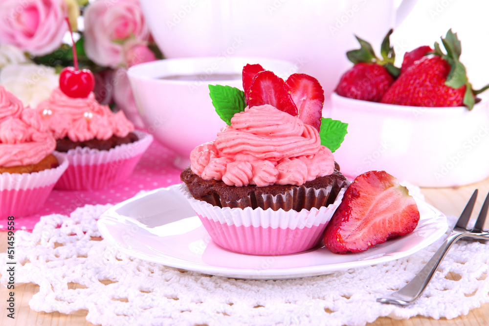 Beautiful strawberry cupcakes on dining table close-up Beautiful strawberry cupcakes on dining table close-up