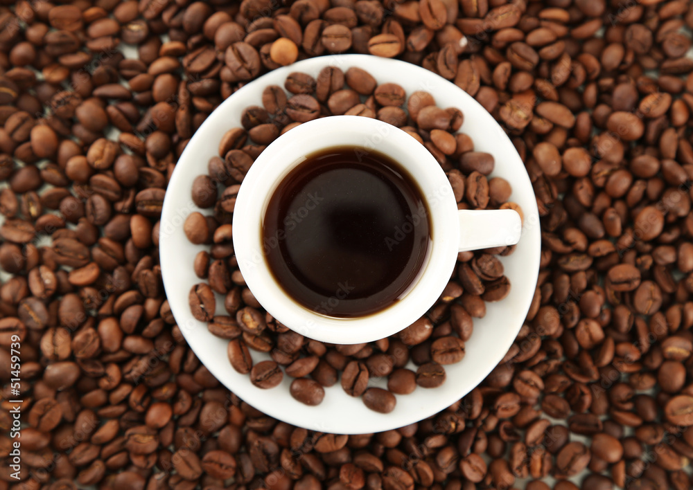Cup of coffee on coffee beans background Cup of coffee on coffee beans background