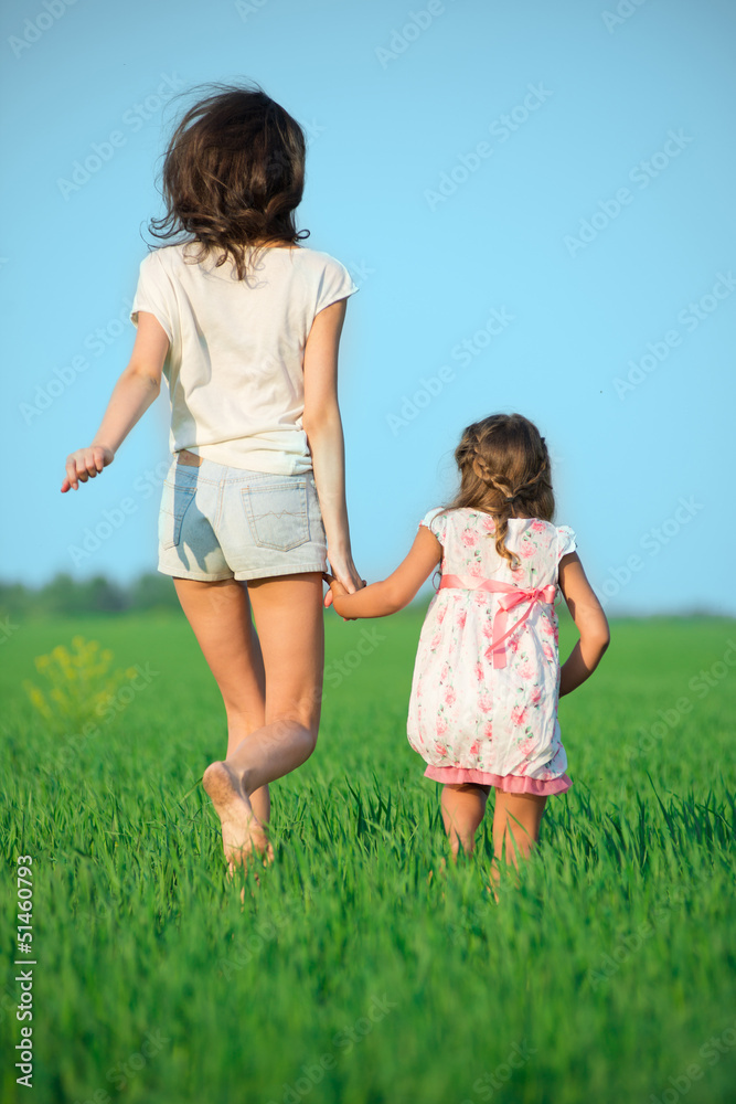 Young happy girls running at green wheat field Young happy girls running at green wheat field