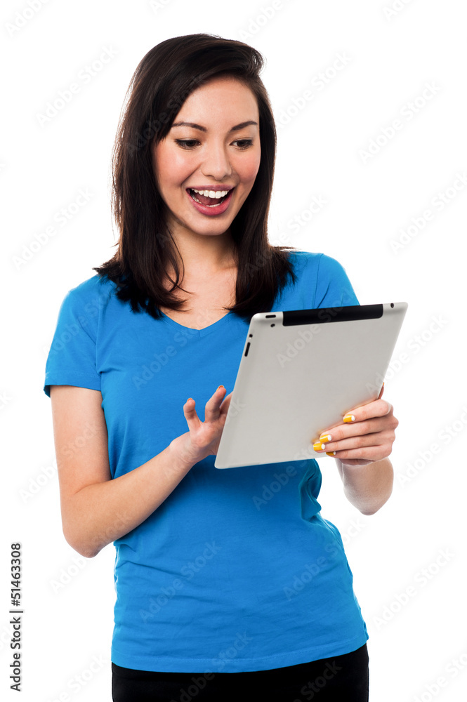 Young girl playing games on tablet device Young girl playing games on tablet device