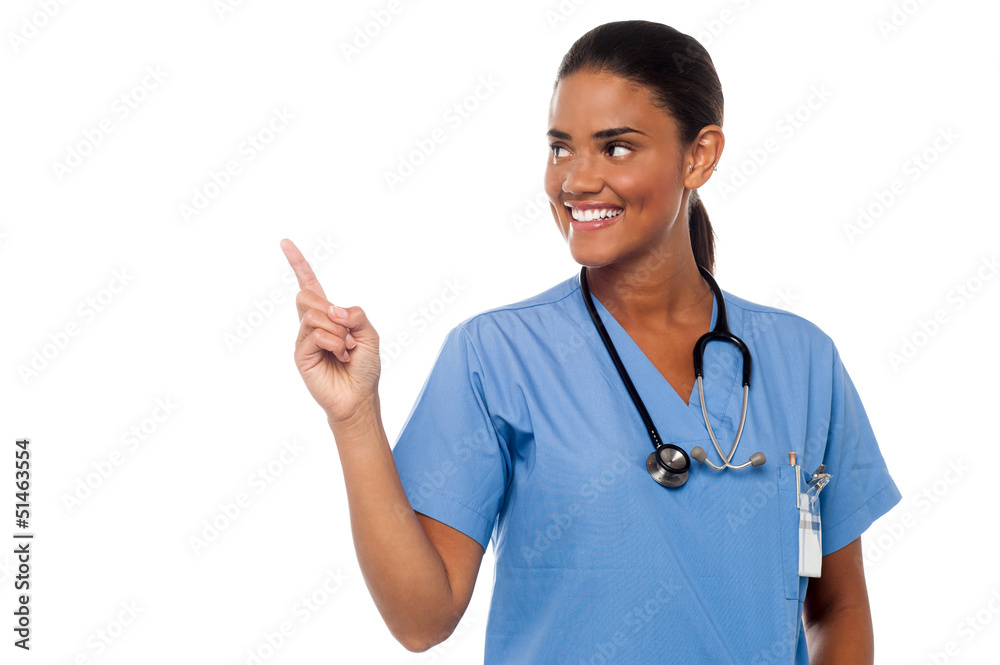 Female physician pointing and looking away Female physician pointing and looking away