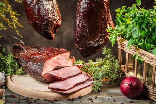 Freshly smoked ham in homemade smokehouse photo