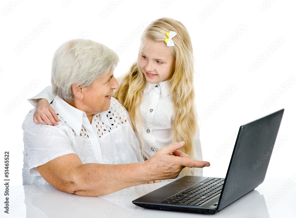 girl teaching and showing computer to her grandmother girl teaching and showing computer to her grandmother