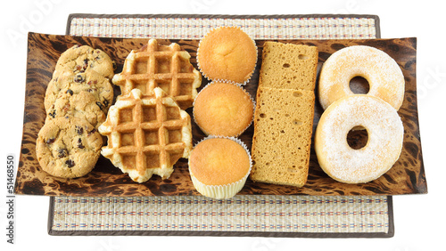 Cakes, cookies, donuts and waffels on the plate
