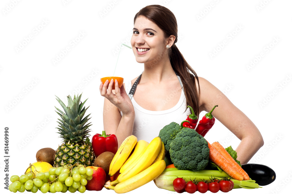 Pretty girl sipping orange juice with a straw Pretty girl sipping orange juice with a straw