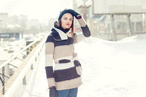 beautiful girl in winter on the streets of the city