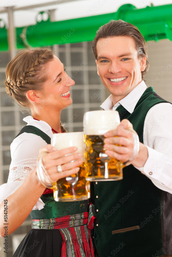 Man and woman with beer glass in brewery Man and woman with beer glass in brewery