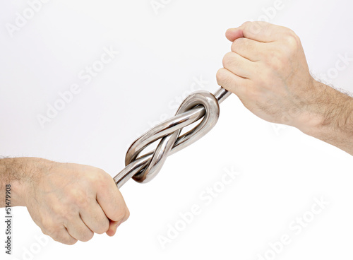 Sturdy knot of iron rod in male hands photo