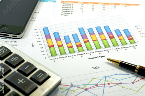 Financial paper charts and graphs with iphone and calculator