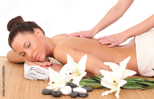 Beautiful woman having relaxing massage on her back in spa salon
