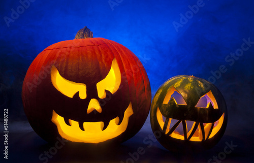 Halloween carved pumpkin and watermelon with blue foggy background