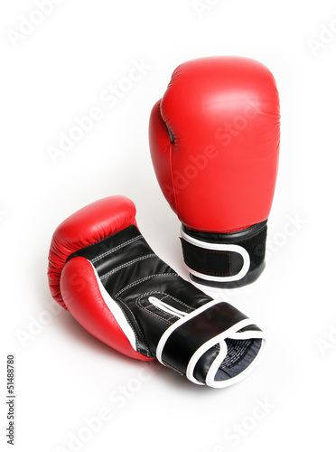 red and black boxing gloves over white background © neillockhart