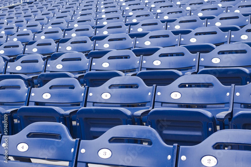 Rows of empty blue stadium seating