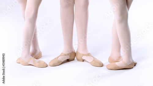 Three girls dancers feet wearing ballet shoes © neillockhart