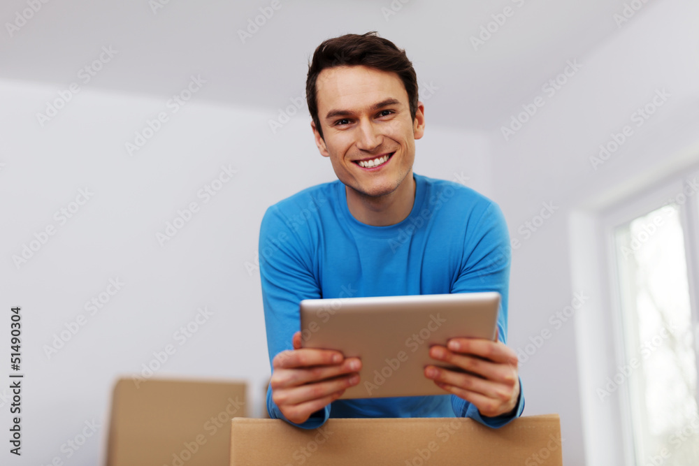 Happy man organize relocation in his new apartment Happy man organize relocation in his new apartment