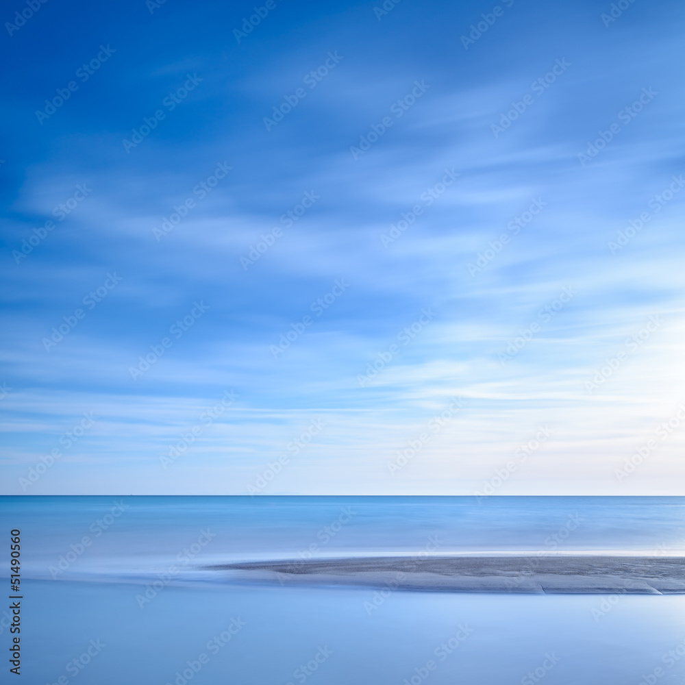 Ocean sandy beach line and blue sunset