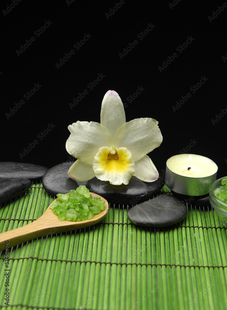 zen stone and sea salt in spoon on green mat zen stone and sea salt in spoon on green mat