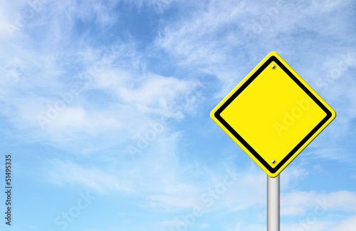 blank yellow traffic sign with blue sky