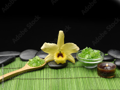 Yellow orchid flower  salt in spoon with zen stone and candle