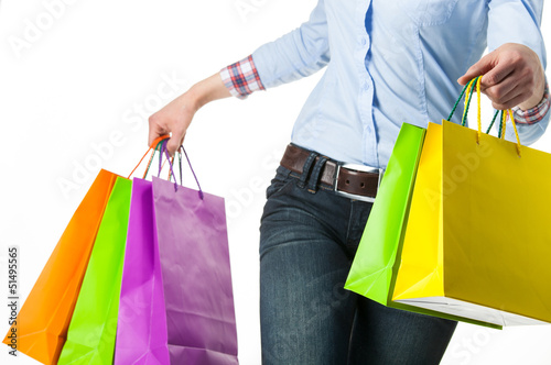 Woman holding multicolored shopping paper bags