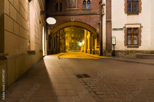mysterious narrow alley with lanterns in Krakow at night #51497567
